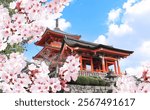 Ancient pavilion and blooming sakura branches, Kiyomizu-dera Temple (Clean Water Temple). Spring time in Kyoto, Japan. Sakura blossom season. Cherry blossoming season in Asia. Japanese hanami festival