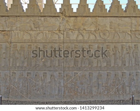Ancient Persian bas-relief from Apadana palace in Persepolis, depicting Persian & Midian nobles & royal courtiers. Upper line of relief showing their servants & chariots. Persepolis, near Shiraz, Iran