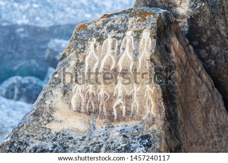Ancient petroglyph depicting human figures in Gobustan, Azerbaijan.