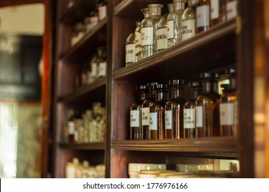 Ancient pharmacy, jars with medicines, transparent brown glass with inscriptions, medicine, health, sale of drugs, wooden shelves