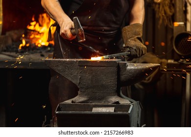 Ancient Professions In The Modern World. Bearded Man, Blacksmith Manually Forging The Molten Metal On The Anvil In Smithy With Spark Fireworks. Concept Of Labor, Retro Vintage Occupation, Family