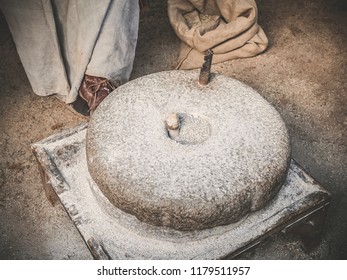 The Ancient Quern Stone Hand Mill. Old Grinding Stones Straw Around