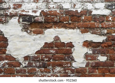 Ancient red brick wall with remaining plaster (stucco) spots; background.
