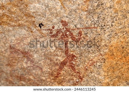 Ancient rock art of painting depicting a human carrying a spear, at Matobo National Park, Zimbabwe, Africa