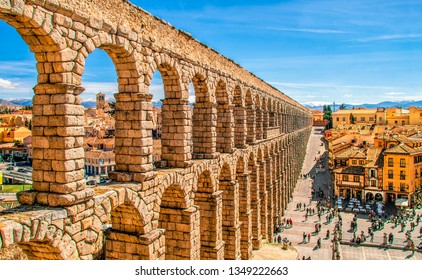 Ancient Roman aqueduct on Plaza del Azoguejo square and old building towns in Segovia, Spain. - Powered by Shutterstock