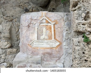 Ancient Roman Carving Of Fascinus Or Winged Phallus In The City Of Pompeii