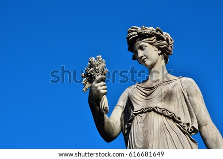 Ancient Roman or Greek neoclassical statue holding wheat in Rome (with copy space)