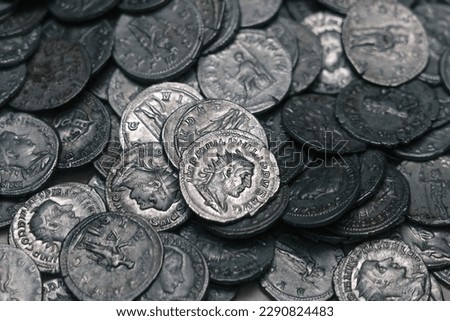 Ancient Roman silver coins on full background. Archaeological treasure (concepts, collecting, riches)