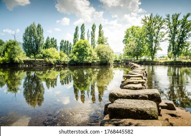 Ancient Roman Stepping Stones Cross The Tâmega River In The City Of Chaves. Portugal.