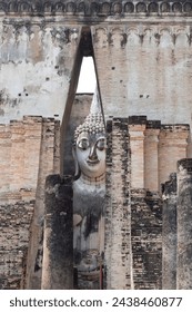 Ancient ruins building of Wat Si Chum temple and antique Pra Ajana buddha statues