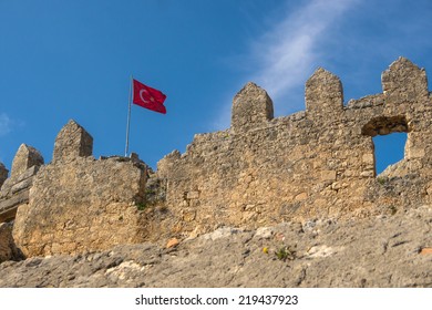 Ancient ruins of Byzantine fortress with Turkish flag in Burch bay near Simena village, Lycia, Turkey. DoF.