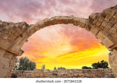 Ancient ruins of the city of Kourion near Paphos and Limassol, Cyprus. Arch of the Castle of Santa Colones against the backdrop of a dramatic sky