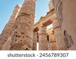 Ancient ruins of Karnak temple in Luxor. Egypt, Great Hypostyle Hall and clouds at the Temples of Karnak (ancient Thebes). Luxor, Egypt