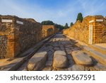 Ancient ruins of Pompei city, Naples, Italy. View of ancient street of Pompeii, Pompei is ancient Roman city destroyed from eruption of Mount Vesuvius in 1st century, Naples, Italy