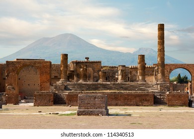 Ancient Ruins Of Pompei With Volcano Vesuvius At Back During Sunset, Italy