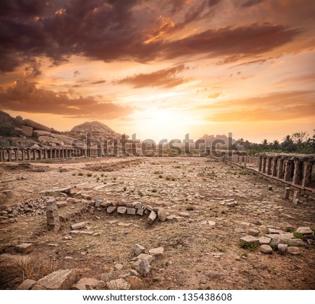 Ancient ruins of Vijayanagara Empire at dramatic sky in Hampi, Karnataka, India