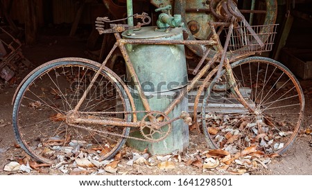 An ancient rusted bicycle used by early settlers, now housed in an old country shed