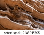 Ancient sandstone deposits that have been eroded over time to form unique patterns and shapes on the canyon walls of Zion National Park, Utah.