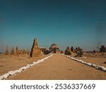 Ancient sandstone tombs at Chaukhandi Graveyard in Karachi, Pakistan. Intricate carvings and geometric patterns cover these centuries-old graves, reflecting Sindh