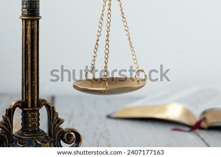 Ancient scales of justice and open holy bible book with white background. Close-up. Selective focus. Judgment, righteousness, Law, authority concept.