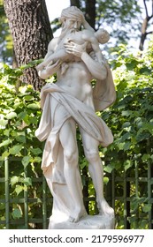 An Ancient Sculpture Of Saturn (Kronos) Eating A Child In The Summer Garden, Created By Peter The Great