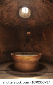 Ancient spa bathroom with a stone bath and roof window