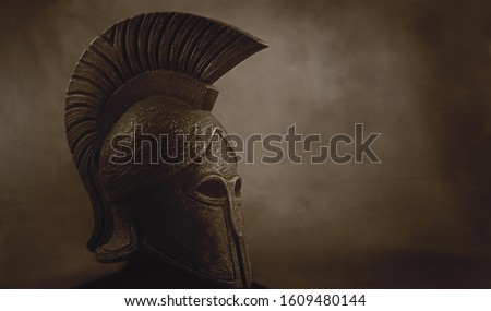 Ancient Spartan (Greek) warrior helmet on a grunge background with copyspace for text. Suitable for TV documentaries, history information etc.