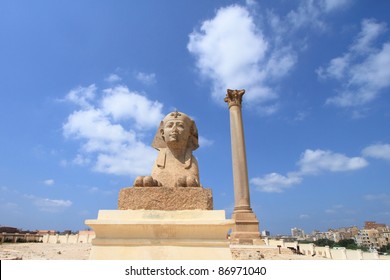 Ancient Sphinx Statue And Pompey's Pillar In Alexandria, Egypt