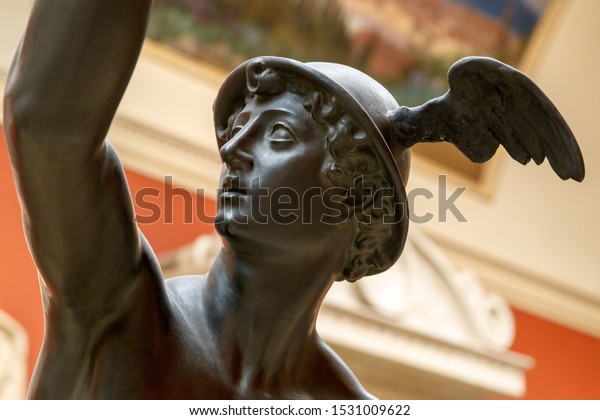 Ancient statue of the antique god of commerce, merchants and travelers Hermes - Mercury. He is olympic gods messenger with wings on a helmet. Sculpture isolated on white background by clipping path