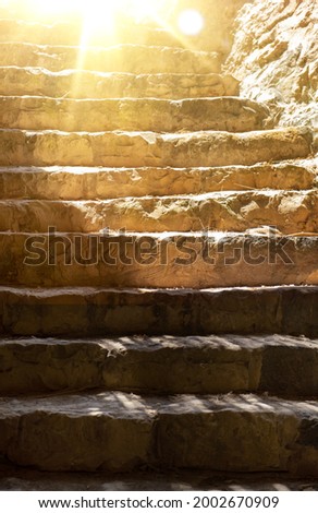 ancient steps on the stairs at the Meggido in Israel. Sunlight shines from above the frame