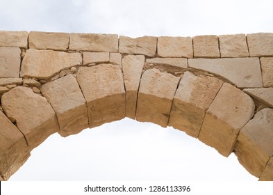 Ancient stone arch and keystone in the sky closeup