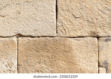 Ancient stone bricks in the wall as a background. Texture.