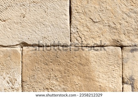 Ancient stone bricks in the wall as a background. Texture.