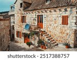 Ancient stone building with tiled roof in Hvar old town, Croatia.