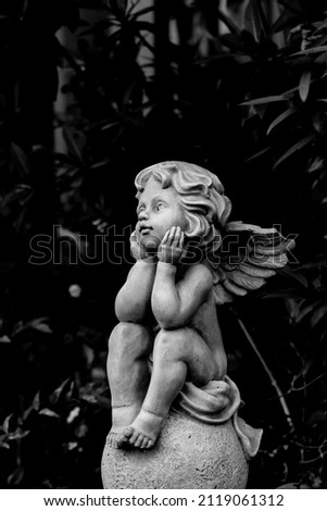 ancient stone doll statue of cute child angle in black and white tone