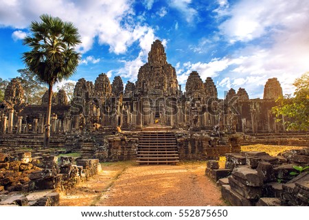 Ancient stone faces at sunset of Bayon temple, Angkor Wat, Siam Reap, Cambodia.