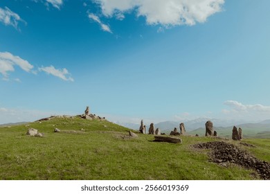 Ancient stone formations in Armenia under a clear blue sky and lush green landscape - Powered by Shutterstock