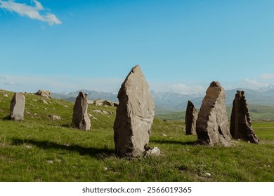 Ancient stone formations stand proudly in the lush Armenian landscape under a bright blue sky - Powered by Shutterstock