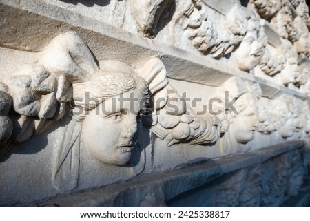 Ancient stone head sculpture in Afrodisias archeology landmark site. Turkey