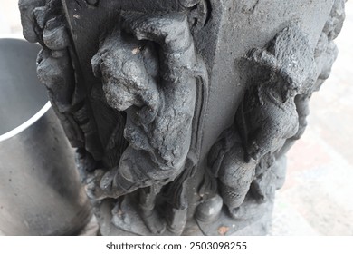 An ancient stone sculpture featuring a weathered, intricately carved figure with a serene expression, showcasing the artistry of a bygone era. - Powered by Shutterstock