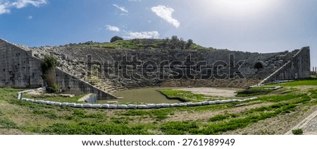 Ancient stone seating of the hellenistic theater at Letoon ancient city, showing curved rows, weathered textures and terraced structure, historic Lycian ruins near city of Xanthos, Mugla, Turkey