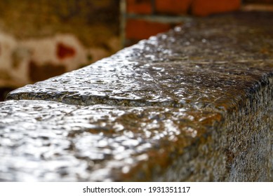 An Ancient Stone Slab That Was Wet On A Rainy Day