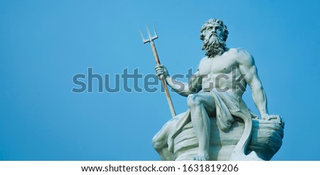 Ancient stone statue of mighty god of the sea and oceans Neptune (Poseidon) with trident.
