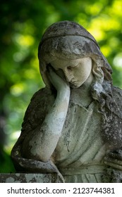 An Ancient Stone Statue Of Sad And Desperate Woman On Tomb As A Symbol Of Death And The End Of Human Life. 