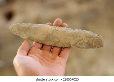 Ancient Stone Tool Isolated On Archaeological Background