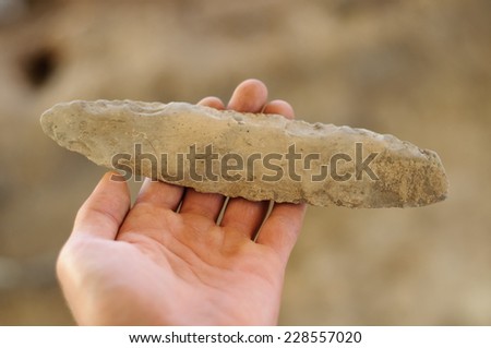 ancient stone tool isolated on archaeological background