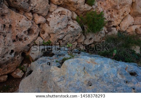 Similar – Beautiful young woman thinking and sitting on the rocks outdoors on the countryside