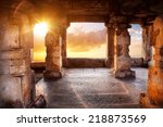 Ancient temple with columns at sunset sky background in India