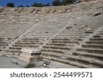 Ancient theatre or amphitheater of Halicarnassus in Greco-Roman style in Bodrum, Turkey. Cutout view on the cavea or seating section. 