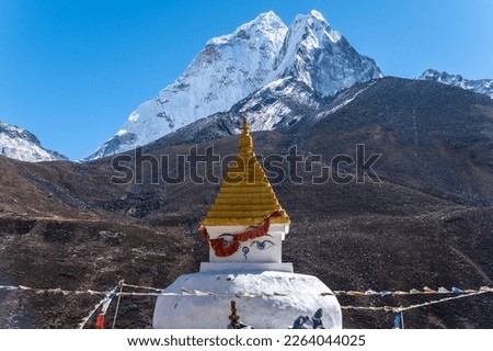 An ancient Tibetan Buddhist stupa with beautiful view of Mt.Ama Dablam view from Dingboche village in rural Nepal.